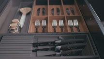 Tracking shot of a kitchen utensils cabinet in a luxury kitchen