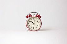 A red retro looking alarm clock