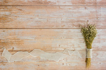 dried flowers bouquet and white ribbon 