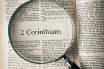 magnifying glass over Bible - 2 Corinthians 
