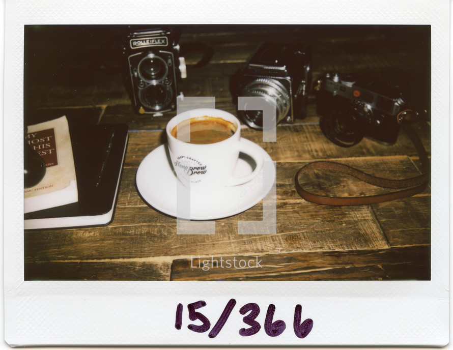 Polaroid of coffee mugs and camera 