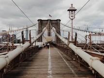 People walking on the Brooklyn bridge.