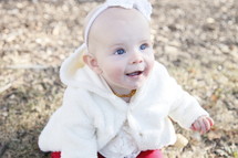 sweet happy bald baby girl infant in red tights