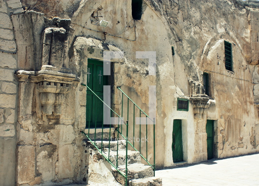 back green doors to the The Church of the Holy Sepulcher, called the Church of the Resurrection by the Greek Orthodox