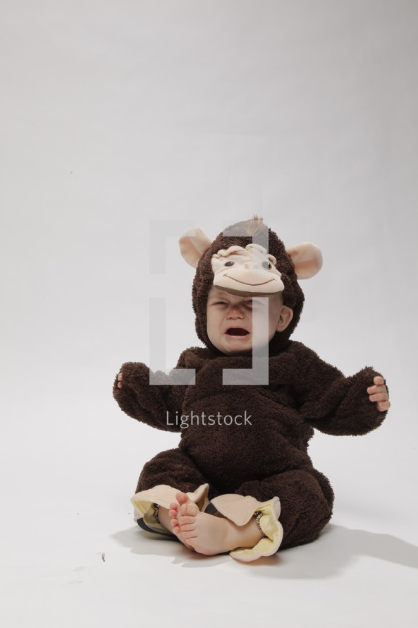 crying toddler in a money costume 