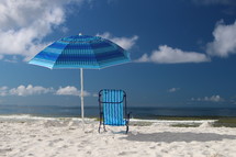 Umbrella and chair on the beach.