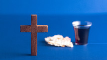 cross and communion elements on blue 