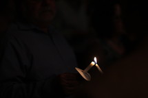 lighting candles at a Christmas Eve worship Service
