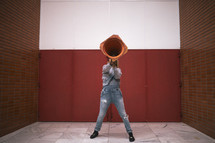 woman using a construction cone as a megaphone 