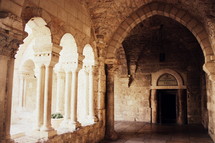 columns and arches in an ancient covered walkway