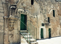 back green doors to the The Church of the Holy Sepulcher, called the Church of the Resurrection by the Greek Orthodox
