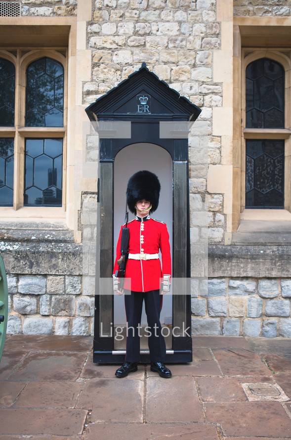 Armed guard in front of a door 
