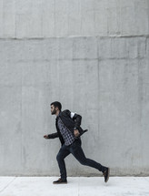 a man running down a sidewalk 