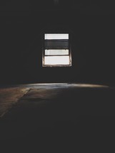light from a window in a dark basement 