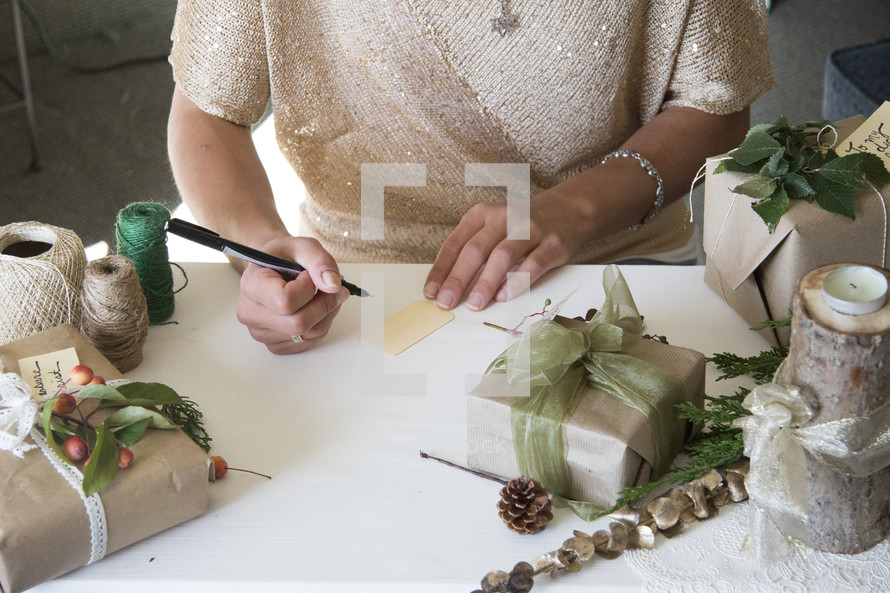 woman writing gift tags for presents 
