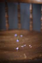 flower petals on a wood chair 