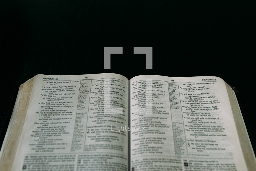 open Bible against a black background 
