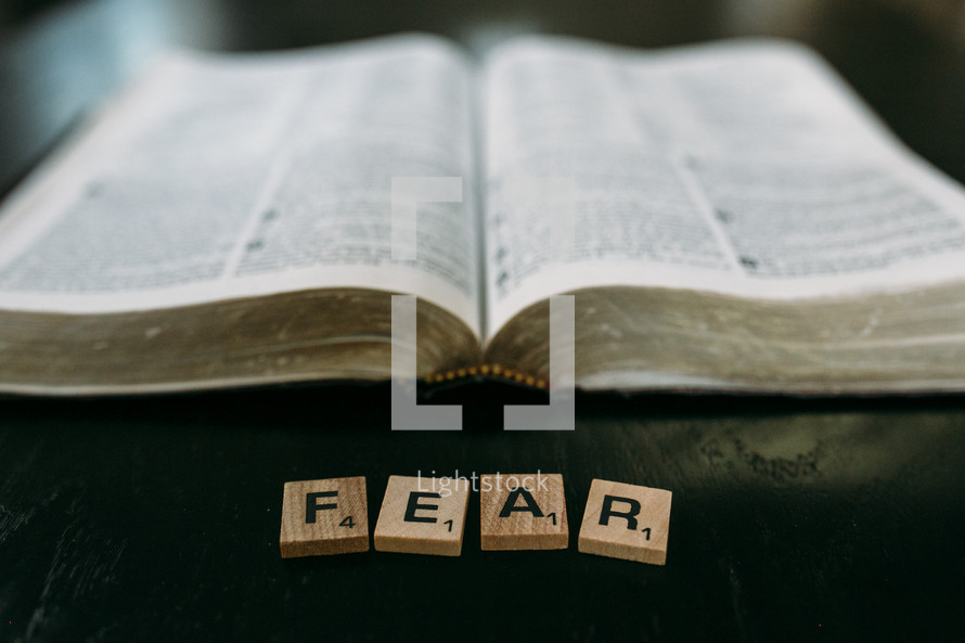 open Bible and the word fear in scrabble pieces 