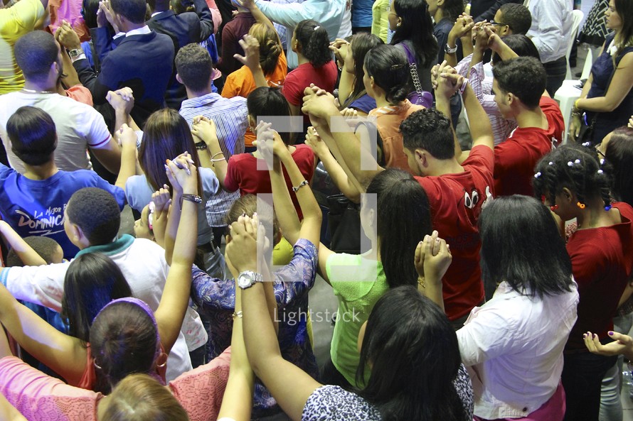 group prayer at a conference worship service 