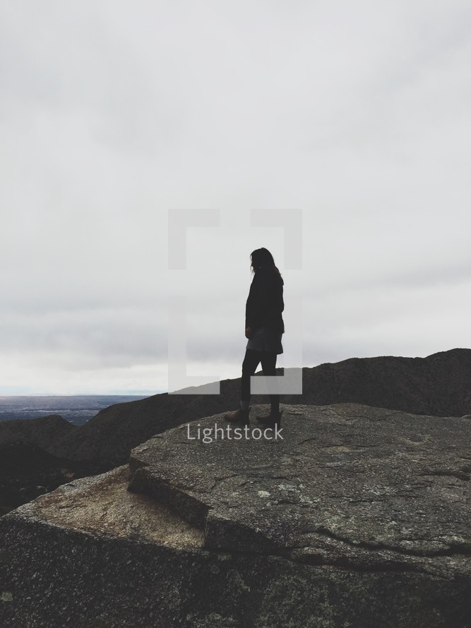 woman standing on a mountain top 