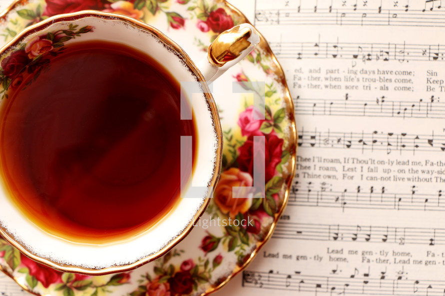 tea in a tea cup and sheet music 