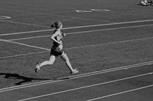 young woman running track 