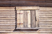 weathered wood shuttered window 