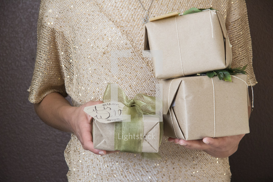 a woman holding Christmas gifts 