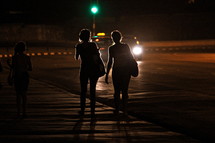 women walking on a sidewalk at night