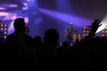 Man playing a guitar leads a worship service.