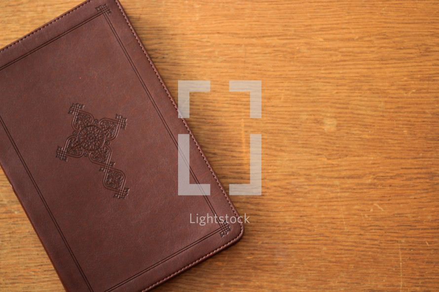 A leather Bible with a cross branded on the cover 