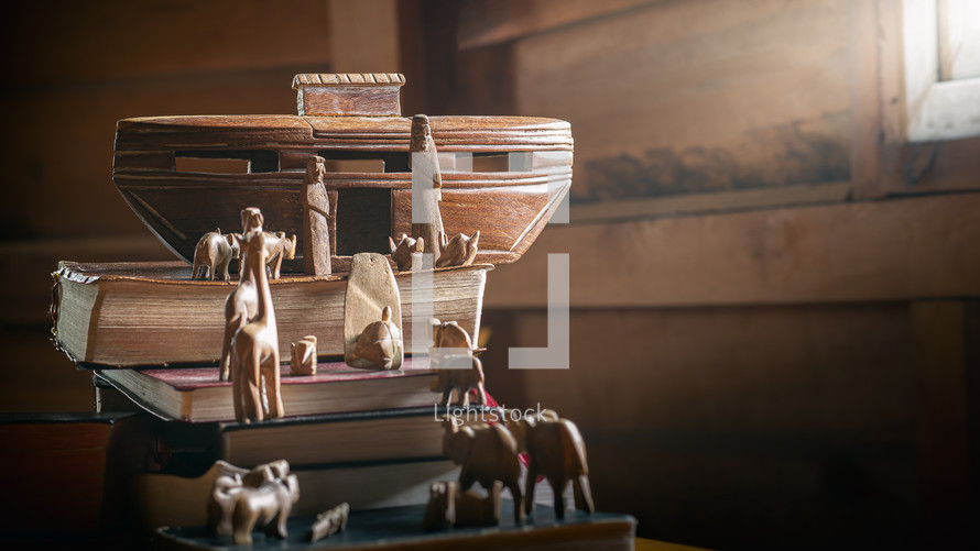 Noah's ark and animals on a stack of books 