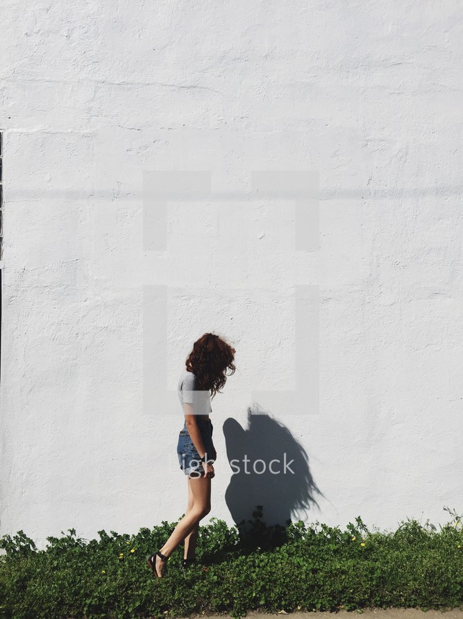 side profile and shadow of a woman outdoors