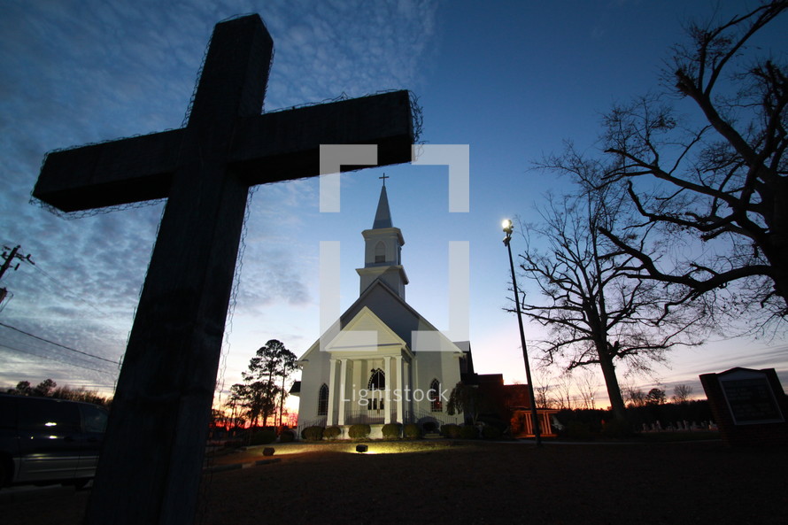 silhouette of a cross Night time country church