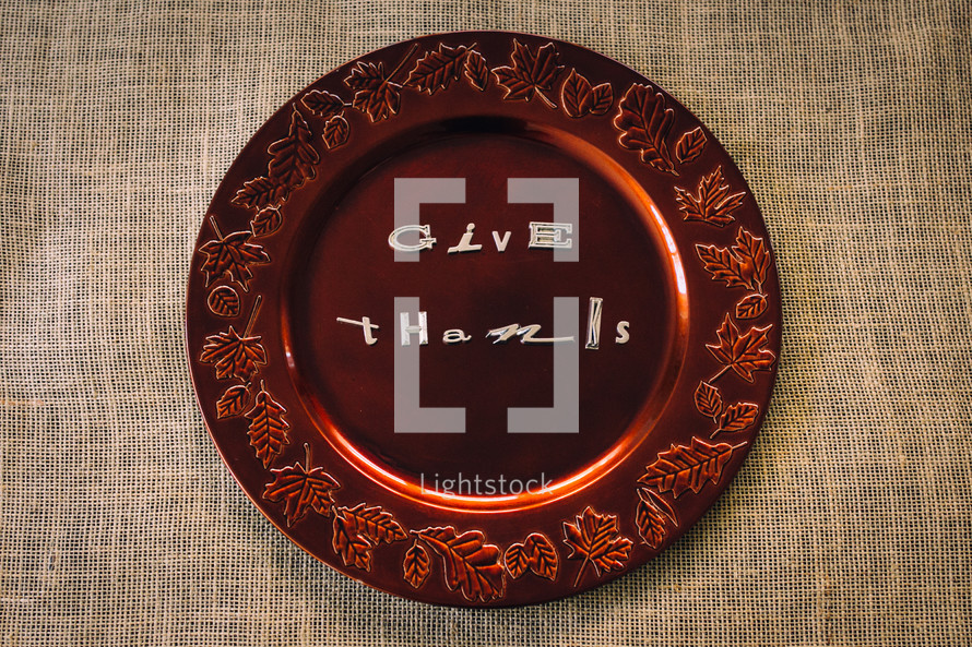 words give thanks on a brown fall plate 