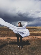 woman waving a white sheet 