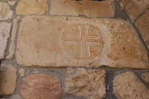 cross stamped into stone 