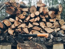 stack of firewood and an ax 