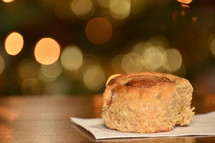 cinnamon roll with Chrismas bokeh in the background