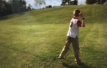 a boy throwing a ball 