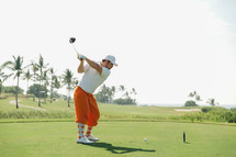 man swinging a golf club 