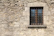 Barred window on castle wall