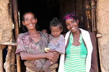 A mother and children in a clay and stick hut in rural Ethiopia.