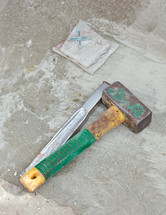 Awl and big hammer on concrete flooring