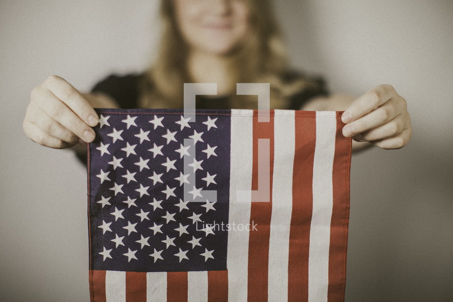 a woman holding an American flag 