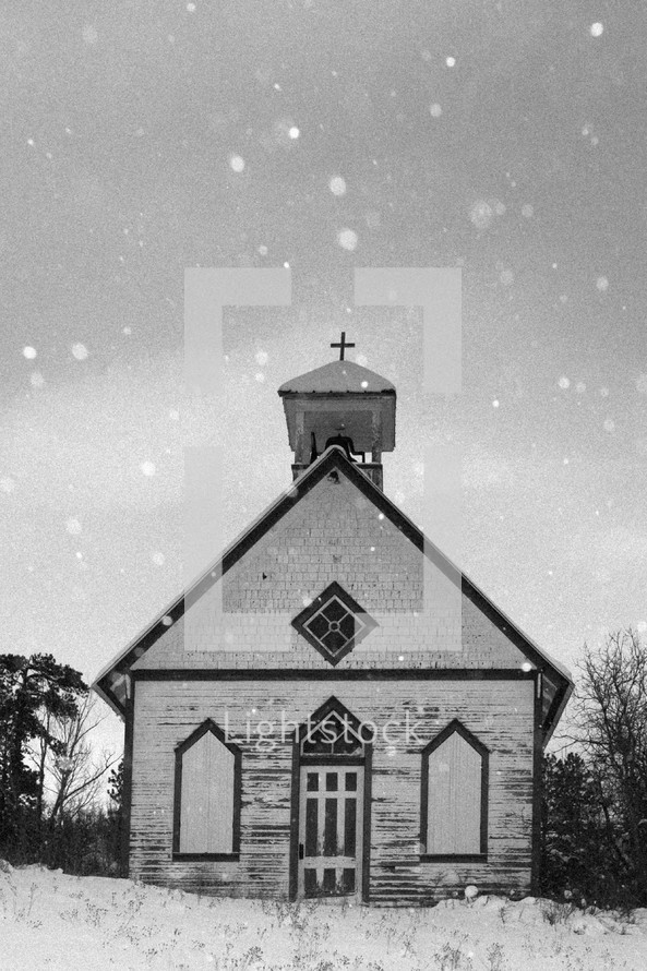 small church in falling snow 