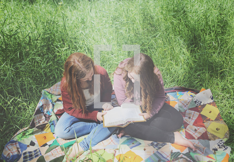 teenage girls reading and studying outside