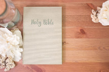 Holy Bible, flower, glass bottles, on a wood