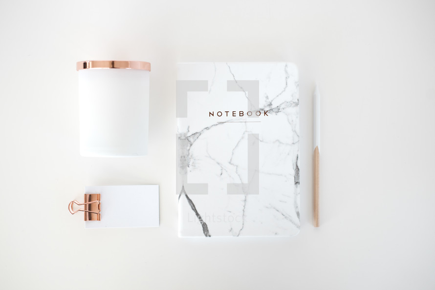 copper and white, notebook, pencil, and notepad on white background 