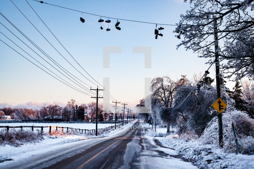 Country road with Shoes on a line after an ice storm in Winter